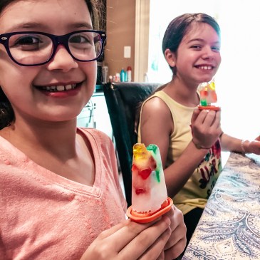 two girls holding homemade ice pops with gummy bears