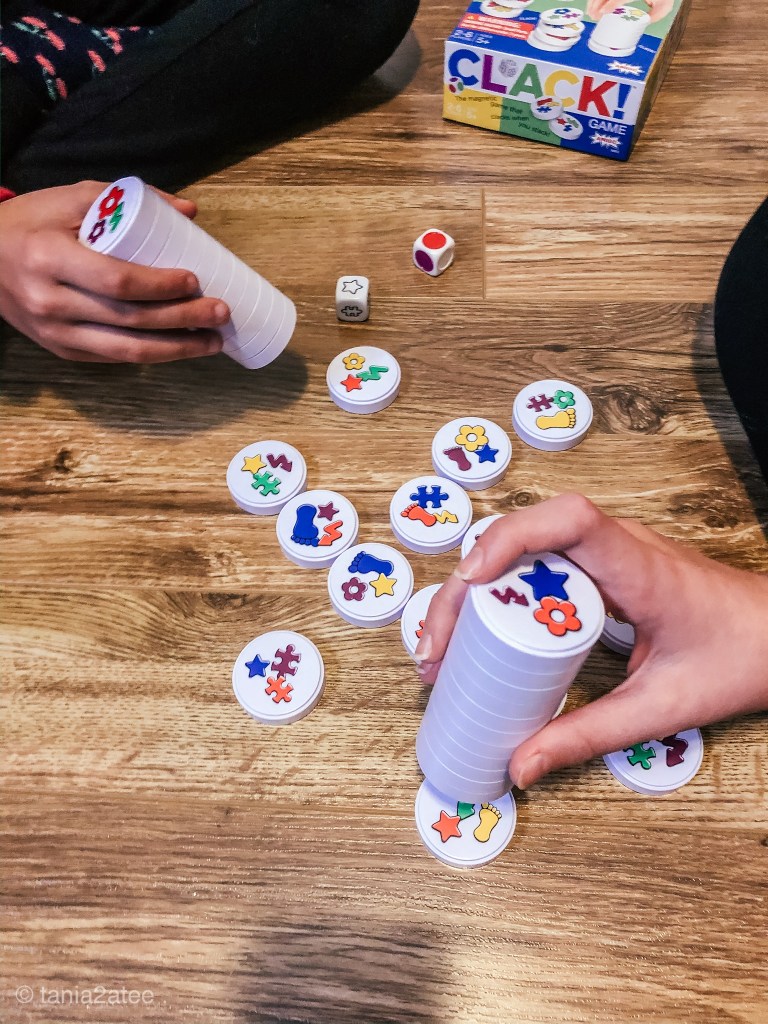two girls playing game collecting pieces from the floor