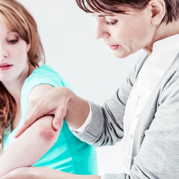 doctor-looking-at-womans-elbow