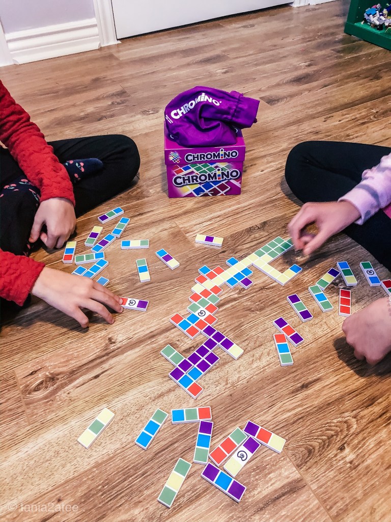 close up of girls playing colourful dominos game