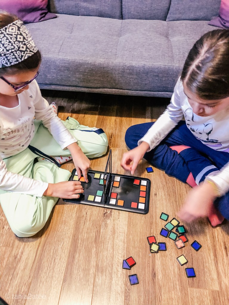 two girls assembling Rubik's Race game