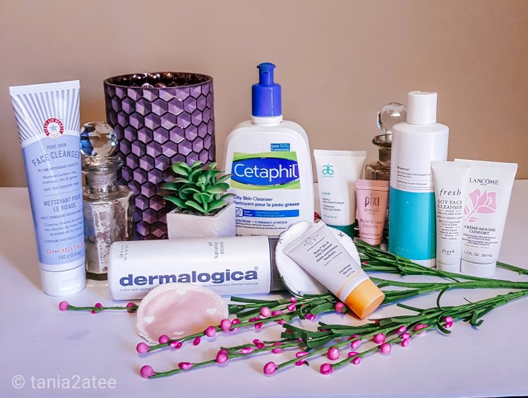 Image of variety of cleansers for face with vases and flowers